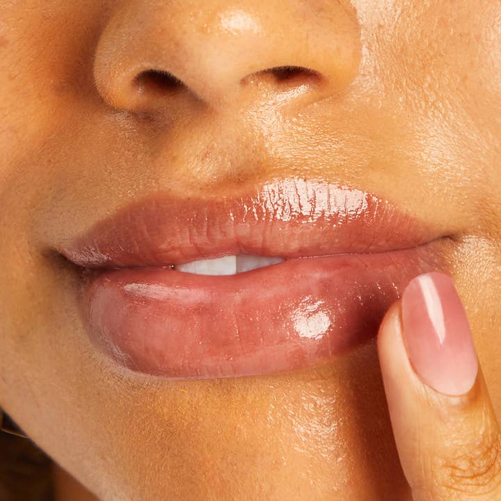 women applying lip balm